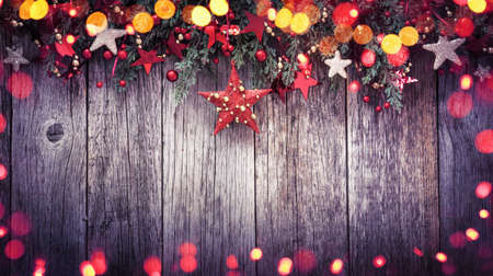 Holidays Decoration Christmas Star on a Wooden Background with Colored Lights Effectsの写真素材