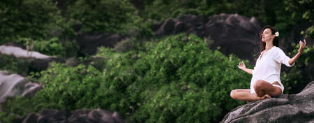 Yoga Concept. Woman Practicing Lotus Pose Enjoying Natureの写真素材