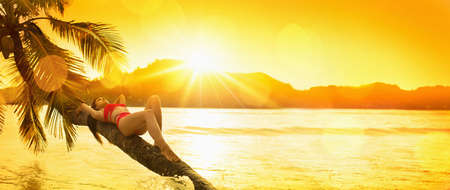 Free Woman Enjoys Ocean Breeze at Sunset. Summer Vacationの写真素材