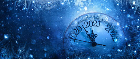 Happy New Years 2021. Winter Celebration With Dial Clock On Snow And Lightの写真素材