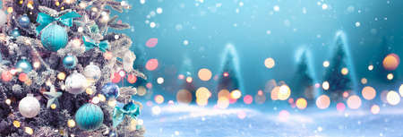 Christmas Tree with Decoration On A Winter Background With Bright Lights And Snowの写真素材