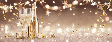 New Years Eve Celebration Background with Champagne and Confetti. Golden Holiday Party