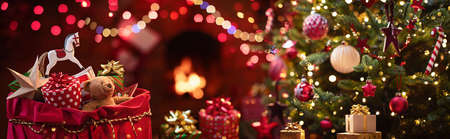 Christmas Gifts. Close Up Gifts And Toys In A Santa Claus Sack Near The Christmas Tree And Fireplaceの写真素材