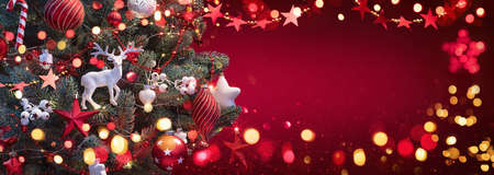 Christmas Tree with Decorations And Stars. Red Winter Backgroundの写真素材