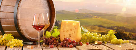 Fresh Grapes And Wine With Cheese On The Background Of An Italian Landscape. Tuscany Regionの写真素材