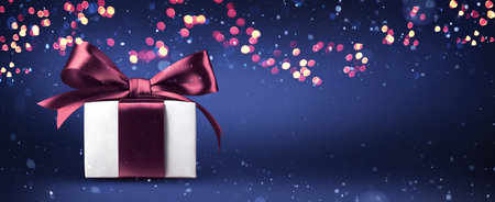Christmas Gift On A Blue Background With Bright Illumination Lightsの写真素材