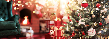 Christmas tree with toys and gifts on the background of a fireplace with fire. Magical room with the throne of Santa Clausの写真素材