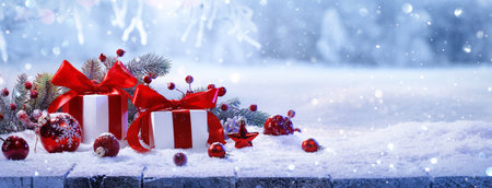 Christmas Gifts With Red Bows On A Winter Forest Backgroundの写真素材