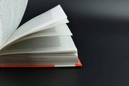 Interesting book image. Opened book on white background. Red book from paperの写真素材