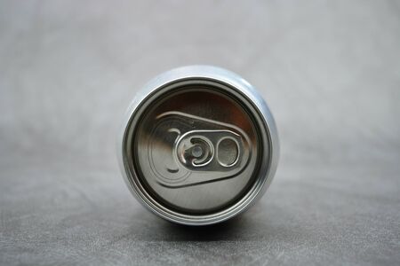 Top view of metal bank. Bank for drink. Silver bank on gray background. Metal cap Jar is on a tableの写真素材