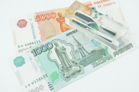 Russian ruble five thousands and one thousand. The time is money. Sand clock and russian money,...