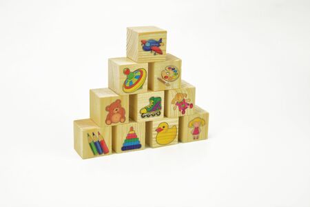 Toy wooden pyramid of blocks with  pictures on a white background