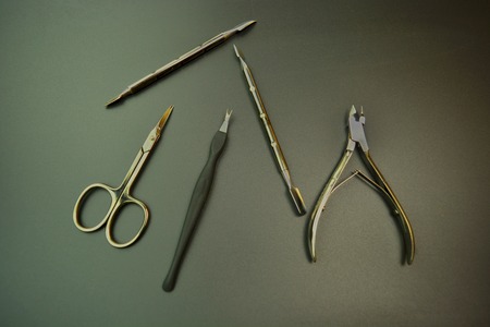 Manicure tools on the black background, scissors