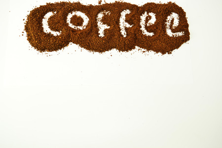 "Coffee" word written on ground coffee layer.の写真素材