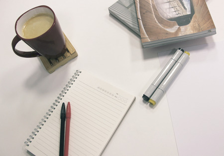 Office table with notebook and stationaryの写真素材