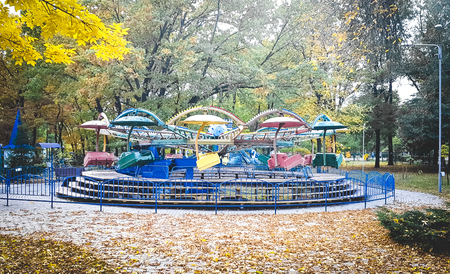 Old soviet carousel in a park during autumn, colorizedの写真素材