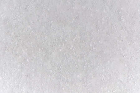 Background of fresh snow white natural texture pattern for minimalistic design in grey tone. Top view witn snowflakes and large cereals. Concept of abstract winter surface with copy space for text.の写真素材