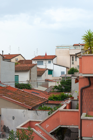 Back yards of Italian houses. The roofs of the houses. Tile. Verticalの写真素材