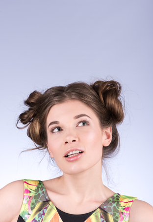 Vertical portrait. Colored dress. Eyes are directed towardsの写真素材