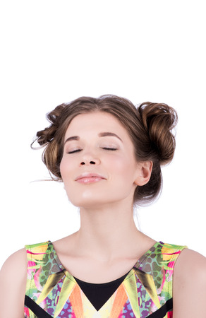 Portrait of young woman with closed eyes enjoying. Gentle nude makeup, hairstyle. Bright colored t-shirtの写真素材