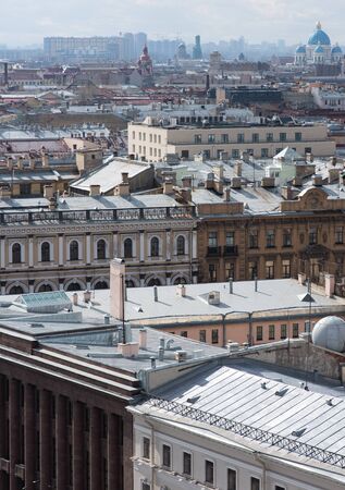 View of the city from a height. Buildings and rooftops, stretching to the horizon. Vertical photoの写真素材