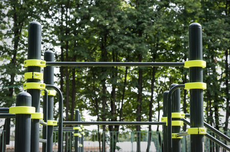 Street sports ground. Horizontal bar. The trees in the background