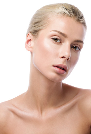 Beauty portrait of beautiful young woman isolated on white background. Professional nude makeup. Sensual look, perfect clean skinの写真素材