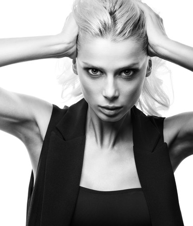 Stylish black and white fashion portrait of beautiful young woman isolated on white background. Expressive imageの写真素材
