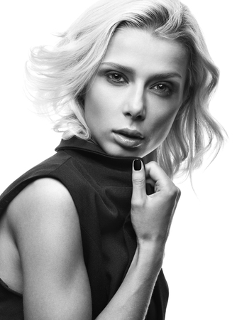 Black and white fashion portrait of beautiful young woman isolated on white background. Sensual look, stylish appearance. Short blonde hairの写真素材