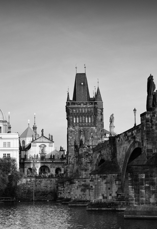 Black-and-white photograph of the Charles bridge. Prague's historical center, photo from the river. Quay and buildings of European cities.の写真素材