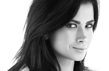 Black and white closeup portrait of a beautiful young woman in black. Sensual look. Isolated on white backgroundの写真素材