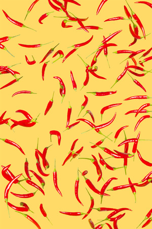 A lot of red spicy peppers on a light yellow background. Conceptual collageの写真素材