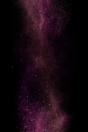 Purple dust on a black background. Fine particles in motionの写真素材
