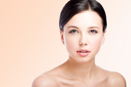 Ð¡loseup beauty portrait. The face of a beautiful young woman. Lips. Perfect skin. Light backgroundの写真素材