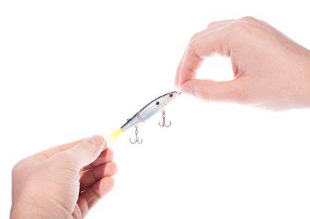 Closeup of male hands holding bait to fish with hooks. Isolated on white backgroundの写真素材