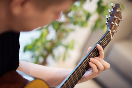 A man playing an acoustic guitar closeup. Learning musicの写真素材