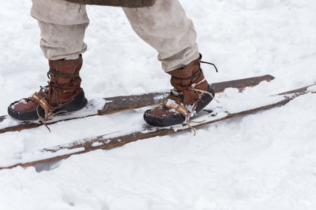 Vintage leather ski boots. Male feet ancient skier. Historical reconstructionの写真素材
