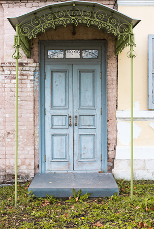The old porch. The facade of the house with the blue doorの写真素材