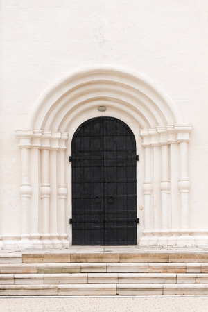 The big black door is the gate to the white building. Architectural details of the pastの写真素材
