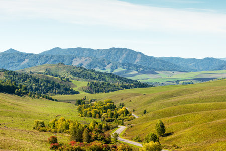 Beautiful autumn landscape. Road, hills and mountainsの写真素材