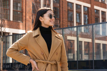 Stylish outdoor portrait. A woman in spring clothes and sunglassesの写真素材