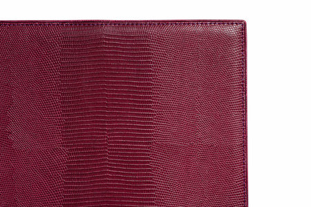 Vinous fine texture of snake leather. Close-up edge isolated at white backgroundの写真素材
