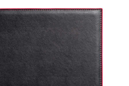 Black fine texture of genuine leather. Close-up edge. Scarlet threds.の写真素材