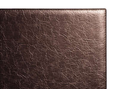 Brown fine texture of genuine leather. Close-up edge isolated at white background.の写真素材