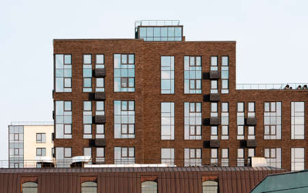 Facade of a modern city brick building. Texture materials. High windows and suspensions for air conditioner.の写真素材