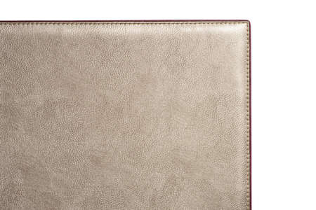 Biege fine texture of genuine leather. Close-up edge isolated at white background.の写真素材
