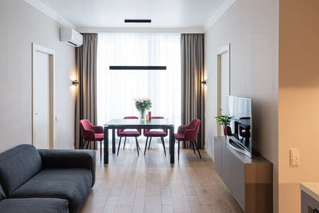 Modern living room interior with big bright window. TV and cozy sofa.の写真素材