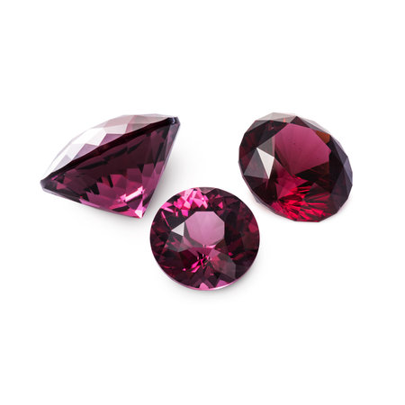 Three faceted red rhodolite garnets isolated on white background.の写真素材