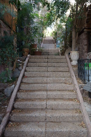 Stone stairs, rock steps twisting upward surrounded by greenery