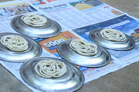 Vilakkudi, Tamilnadu India - November 09 2020: Preparing South Indian Homemade rice Murukku for...